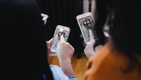 Two persons with mobile phones